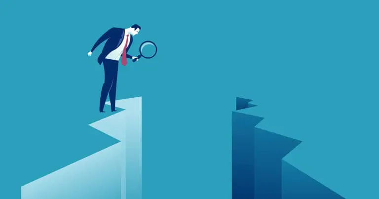 digital illustration of a man in a suit standing on the edge of a cliff and holding a magnifying glass to inspect the gap between him and another cliff across from him to symbolize a gap inspection or auit