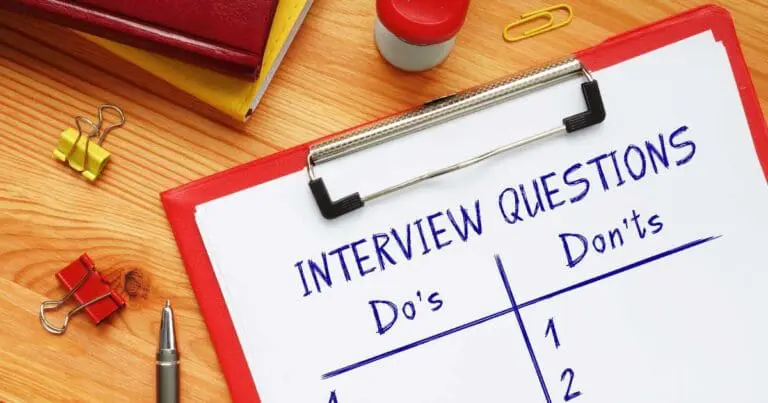Photo of a clipboard on a desk with a paper that reads "interview questions do's and don'ts"